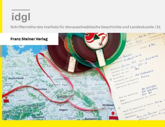 Cover des Bandes: Titelangaben sowie eine Tonbandspule mit abgewickeltem Tonband und einem Schriftstück auf einer Europakarte