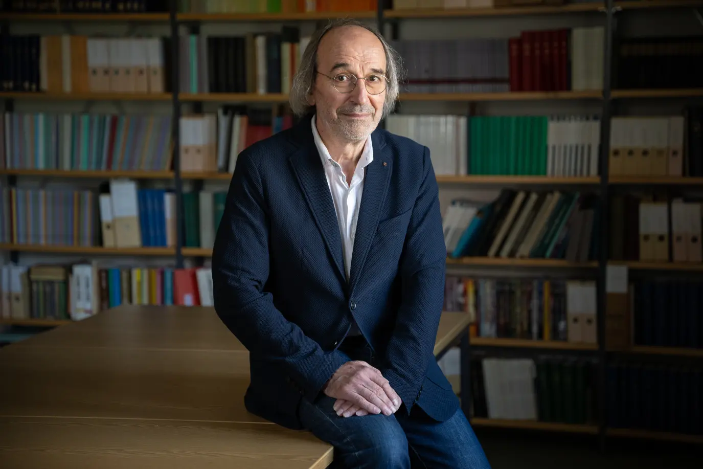 Das Foto zeigt Dr. Mathias Beer vor einem Bücherregal.